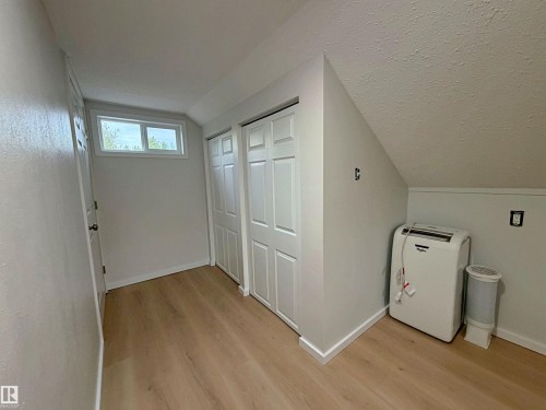 Room featuring light wood-finish flooring, white baseboards, and a window providing natural light - 60016 Rr 41, Rural Barrhead County, AB - Indoor Photo Showing Other Room