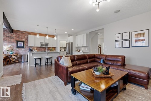 Open-concept living area featuring wood-finish flooring - 1359 Westerra Drive, Stony Plain, AB - Indoor Photo Showing Living Room