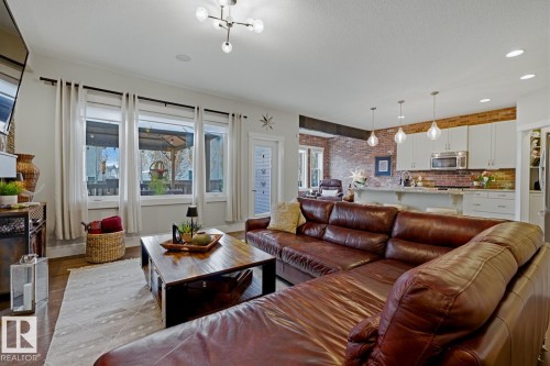 Open-concept living area with wood-finish flooring - 1359 Westerra Drive, Stony Plain, AB - Indoor Photo Showing Living Room