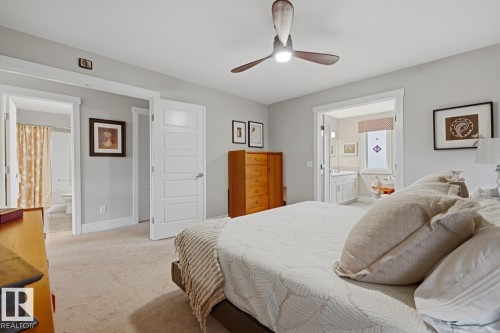 Carpeted bedroom with a ceiling fan, light gray walls, and white trim - 1359 Westerra Drive, Stony Plain, AB - Indoor Photo Showing Bedroom