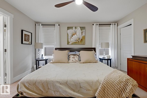 Carpeted room with a ceiling fan, light gray wall paint, and white trim - 1359 Westerra Drive, Stony Plain, AB - Indoor Photo Showing Bedroom