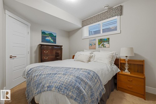 Carpeted room featuring a horizontal window with blinds and a patterned valance - 1359 Westerra Drive, Stony Plain, AB - Indoor Photo Showing Bedroom