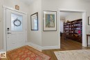Entryway featuring a white paneled door with decorative glass inserts, modern door hardware, and light-toned tile flooring - 1359 Westerra Drive, Stony Plain, AB  - Indoor Photo Showing Other Room 
