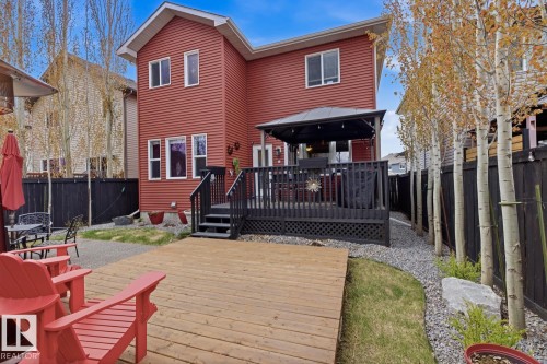Rear exterior of a two-story residence with vibrant red siding - 1359 Westerra Drive, Stony Plain, AB - Outdoor With Deck Patio Veranda