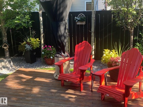 Wood-finish decking with a dark-stained privacy fence, mature trees, and decorative planters - 1359 Westerra Drive, Stony Plain, AB - Outdoor