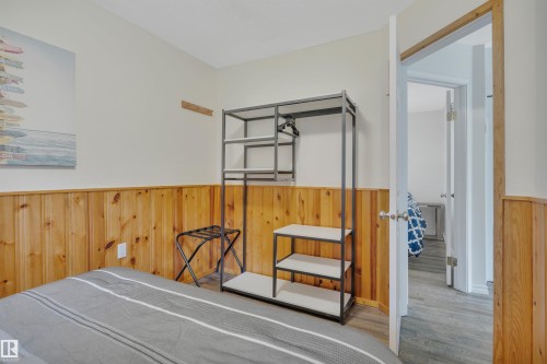 Room featuring natural wood paneling along the lower walls and light-colored upper walls - 305 3 St, Rural Wetaskiwin County, AB - Indoor Photo Showing Other Room