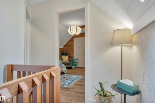 Wood-finish flooring extending into the room beyond - 305 3 St, Rural Wetaskiwin County, AB - Indoor