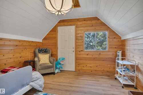 Interior space featuring wood-paneled walls and sloped ceilings with white paneling - 305 3 St, Rural Wetaskiwin County, AB - Indoor