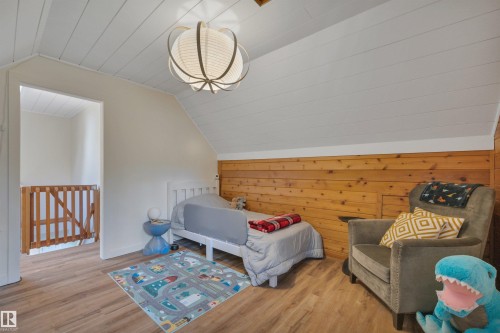 Attic space featuring wood-finish flooring and a whitewashed planked ceiling - 305 3 St, Rural Wetaskiwin County, AB - Indoor
