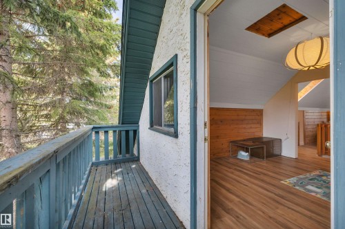 Outdoor balcony with wood plank flooring and wood railing - 305 3 St, Rural Wetaskiwin County, AB - Outdoor With Exterior