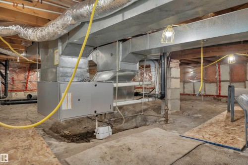 Basement utility space featuring exposed wood joists, ductwork, and electrical wiring - 305 3 St, Rural Wetaskiwin County, AB - Indoor Photo Showing Basement