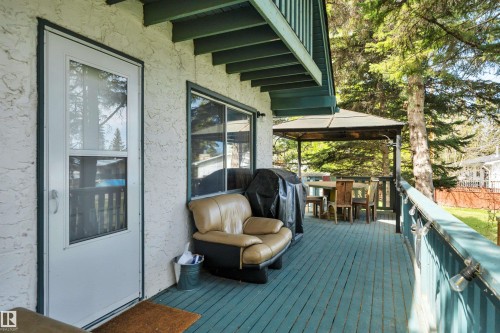 Exterior deck featuring a screened door, overhead balcony, and a covered gazebo - 305 3 St, Rural Wetaskiwin County, AB - Outdoor With Deck Patio Veranda With Exterior