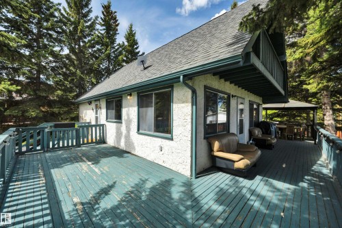 Expansive outdoor deck featuring a gazebo, second-story balcony, multiple exterior light fixtures, and a textured stucco exterior - 305 3 St, Rural Wetaskiwin County, AB - Outdoor With Deck Patio Veranda With Exterior