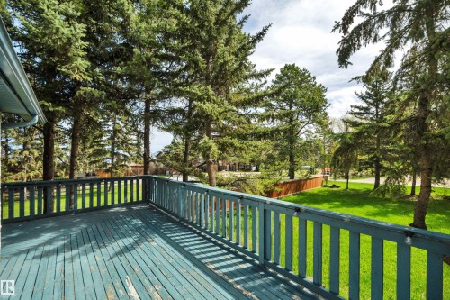 Expansive wooden deck featuring perimeter railing and integrated solar lights - 305 3 St, Rural Wetaskiwin County, AB - Outdoor With Deck Patio Veranda