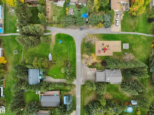 Aerial perspective showcasing a residential area with mature trees and green spaces - 305 3 St, Rural Wetaskiwin County, AB - Outdoor With View