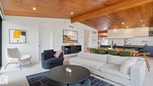 Open-concept living space featuring a wood-panel ceiling, recessed lighting, and light-toned flooring - 6412 Ada Boulevard, Edmonton, AB - Indoor Photo Showing Living Room