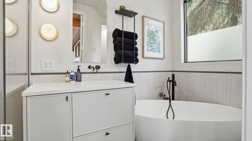 Freestanding soaking tub with matte black fixtures - 6412 Ada Boulevard, Edmonton, AB - Indoor