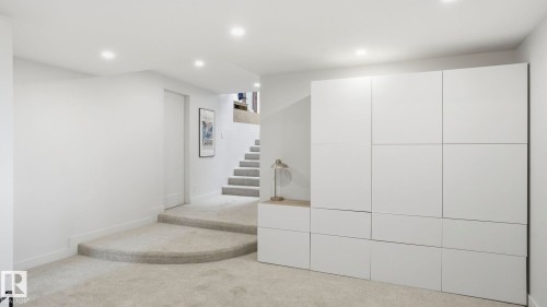 Integrated storage cabinetry with a light wood-finish countertop - 6412 Ada Boulevard, Edmonton, AB - Indoor