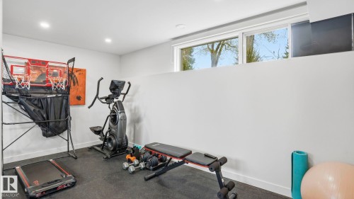 Dedicated fitness space featuring recessed lighting, a durable rubber floor, and egress windows for natural light - 6412 Ada Boulevard, Edmonton, AB - Indoor Photo Showing Gym Room