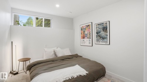 Bright bedroom featuring a high-set window, recessed ceiling lighting, and light-colored carpeting - 6412 Ada Boulevard, Edmonton, AB - Indoor Photo Showing Bedroom