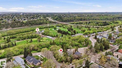 Aerial perspective showcasing a residential area bordered by extensive green spaces, a river, and a golf course - 6412 Ada Boulevard, Edmonton, AB - Outdoor With View