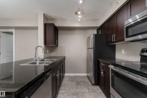409 5804 Mullen Place, Edmonton, AB - Indoor Photo Showing Kitchen With Stainless Steel Kitchen With Double Sink