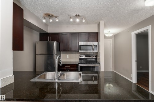 409 5804 Mullen Place, Edmonton, AB - Indoor Photo Showing Kitchen With Stainless Steel Kitchen With Double Sink