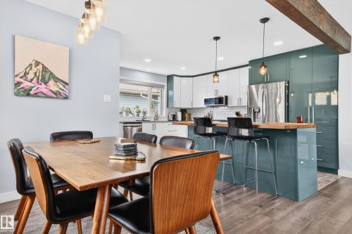 Open concept kitchen and dining area featuring wood-finish flooring - 6707 92B Avenue, Edmonton, AB - Indoor Photo Showing Dining Room
