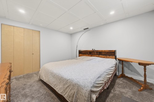 Carpeted room with light grey walls, a paneled drop ceiling, and recessed lighting - 6707 92B Avenue, Edmonton, AB - Indoor Photo Showing Bedroom