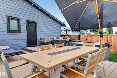 Expansive outdoor deck featuring composite decking and a built-in hot tub - 6707 92B Avenue, Edmonton, AB - Outdoor With Deck Patio Veranda With Exterior