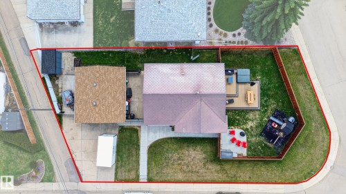 Property featuring a shingled roof, an attached garage, a paved driveway, and a fenced backyard - 6707 92B Avenue, Edmonton, AB - 