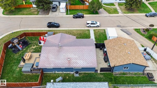 Private backyard featuring a wood deck, fenced perimeter, and a dedicated play area - 6707 92B Avenue, Edmonton, AB - Outdoor
