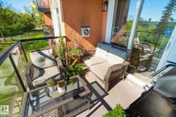 Private balcony featuring a glass railing system and durable exterior tile flooring - 