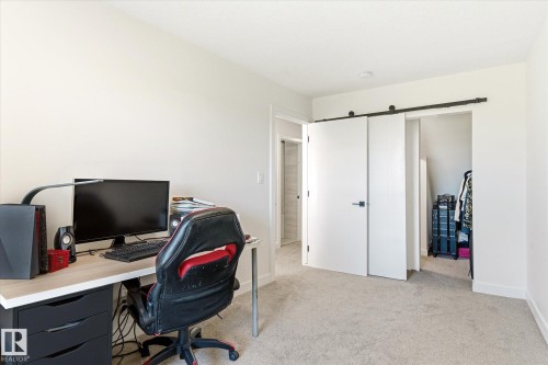 Neutral-toned room featuring light carpet flooring and white walls - 108 10105 95 Street, Edmonton, AB - Indoor Photo Showing Office