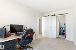 Neutral-toned room featuring light carpet flooring and white walls - 