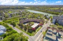 Aerial perspective showcasing a complex of brick residential buildings, surrounded by mature trees and verdant landscapes - 108 10105 95 Street, Edmonton, AB  - Outdoor With View 