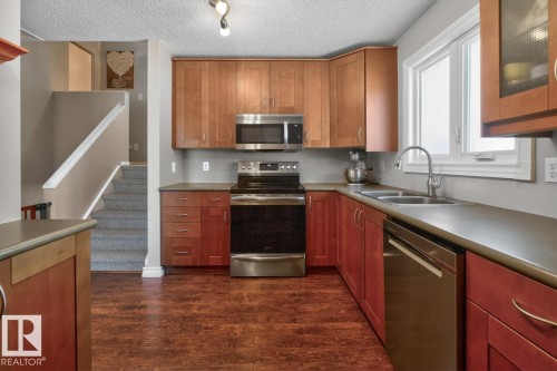 Kitchen featuring Stainless Steel Appliances, Ample Cabinets, Counter Space, and Storage with South Facing Window overlooking your Private Backyard. - 18655 61 Avenue, Edmonton, AB - Indoor Photo Showing Kitchen With Double Sink