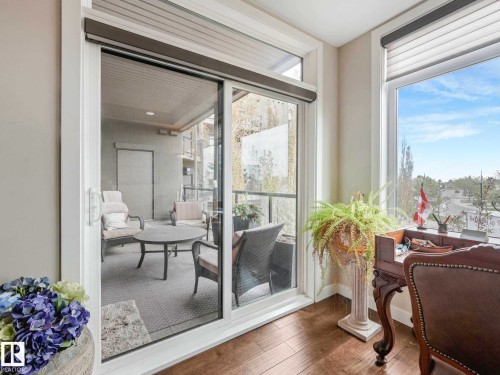 Sliding glass patio doors opening to an outdoor living area - 213 625 Leger Way, Edmonton, AB -  Photo Showing Other Room