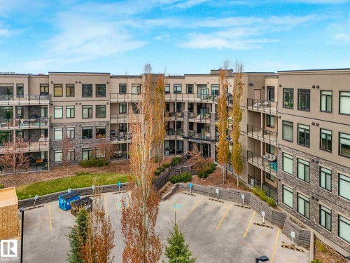 Multi-story residential building with private balconies and exterior stone accents - 213 625 Leger Way, Edmonton, AB - Outdoor With Balcony