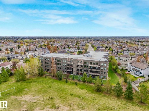Modern multi-story building featuring multiple balconies and a flat roofline - 213 625 Leger Way, Edmonton, AB - Outdoor With View
