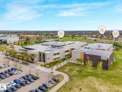 Expansive campus featuring multiple modern buildings with flat roofs and solar panel installations - 213 625 Leger Way, Edmonton, AB - Outdoor With View