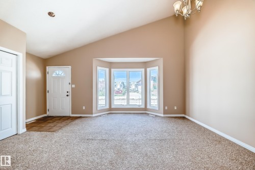 Inviting entry area with vaulted ceilings and a multi-pane front door - 9825 156 Street, Edmonton, AB - Indoor Photo Showing Other Room