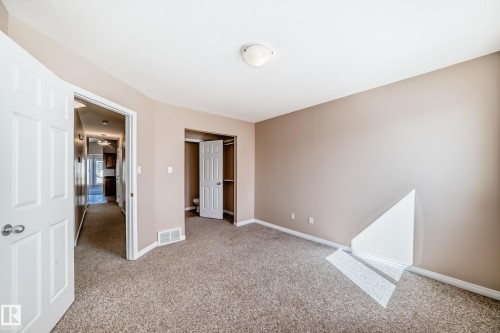 Carpeted room with neutral paint, white trim, and a flush mount ceiling light - 9825 156 Street, Edmonton, AB - Indoor Photo Showing Other Room