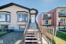 Property exterior featuring light-toned siding with dark trim accents - 9825 156 Street, Edmonton, AB  - Outdoor 