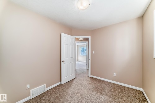 Carpeted room with neutral paint tones and white trim - 9825 156 Street, Edmonton, AB - Indoor Photo Showing Other Room