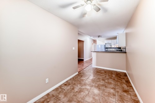 Open-concept dining area featuring ceramic tile flooring and a ceiling fan - 9825 156 Street, Edmonton, AB - Indoor Photo Showing Other Room