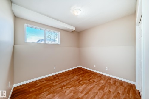 Neutral painted walls with white trim and wood-finish flooring - 9825 156 Street, Edmonton, AB - Indoor Photo Showing Other Room