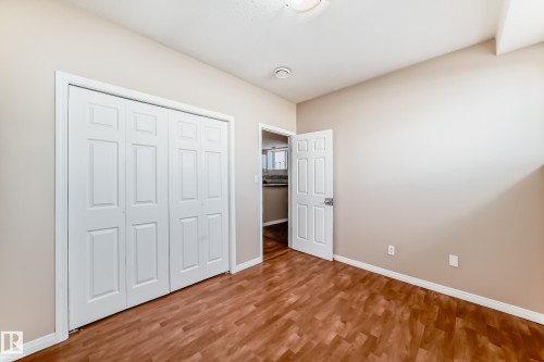 Interior space featuring wood-finish flooring, light tan wall color, and white trim - 9825 156 Street, Edmonton, AB - Indoor Photo Showing Other Room