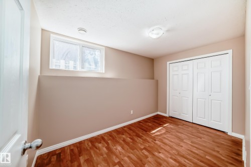 Interior room featuring wood-finish flooring, neutral wall tones, and white trim - 9825 156 Street, Edmonton, AB - Indoor Photo Showing Other Room