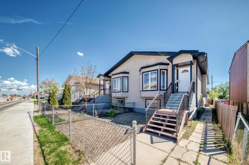 Exterior featuring light-colored siding with dark trim accents - 9825 156 Street, Edmonton, AB - Outdoor